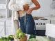 beautiful sporty woman kitchen with vegetables