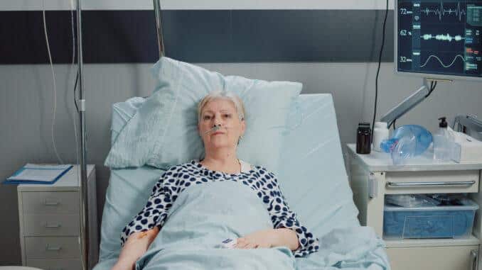 elder patient with iv drip bag nasal oxygen tube laying bed aged woman with disease receiving healthcare treatment recovery hospital ward waiting medical support