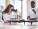 lab assistant with microscope laboratory glassware bulb with chemicals
