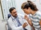 coughing woman visiting doctor clinic patient coughing medical appointment with her doctor sick woman visiting doctor hospital